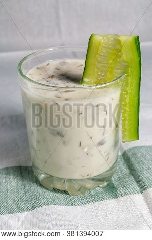 Glass Cup With Fermented Caucasian And Turkish Milk Product Decorated With A Slice Of Cucumber