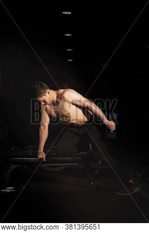 Handsome Man Raising Dumbbell,doing Exercise For Buit Muscle,fit And Firm Body,model Posing,blurry L