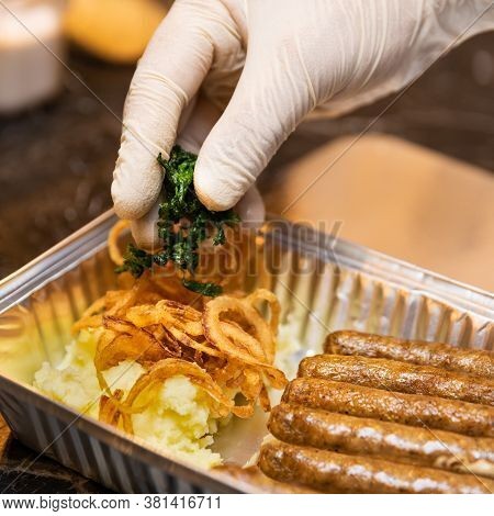 Chef Putting Greens On The German Sausages