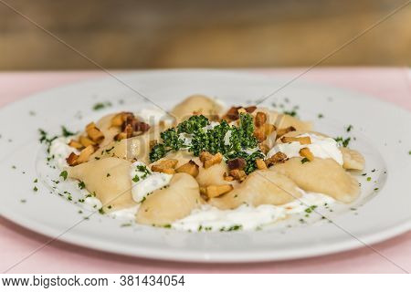 Traditional Slovak food - Bryndzove pyrohy with bacon on plate. The food in the restaurant. Food styling and restaurant meal serving.
