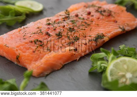 A Piece Of Lightly Salted Salmon On A Black Background Close Up