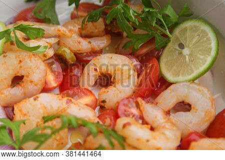 Fresh Raw Peeled Prawns With Sliced Cherry Tomatoes, Herbs And Spices.