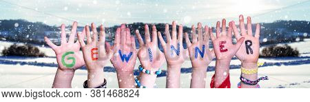 Children Hands Building Word Gewinner Means Winner, Snowy Winter Background