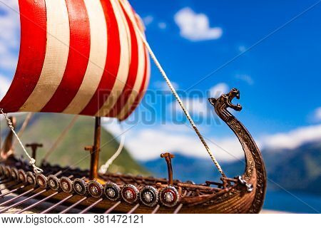 Old Wooden Viking Longboat Sails, Drakkar Boat On Fjord Shore In Norway. Tourism And Traveling Conce
