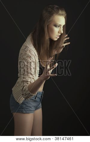 在侵略性姿势性感女孩的低关键肖像