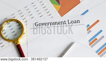 Paper With Govenment Loan On Charts With Office Tools