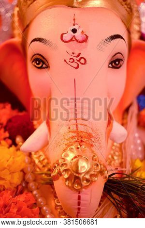 Abstract Background Of Lord Ganesha Elephant Face Head & Eyes Close Up With Hindu Religion Om Sign S