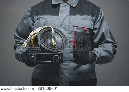 Car Audio Specialist Is Holding In Hand A Car Stereo Equipment And Is Showing A Thumbs Up.
