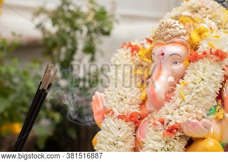 Incense Or Agarbatti Sticks In Front Of Lord Vinayaka Or Ganesha While Worshiping During Ganesha Cha