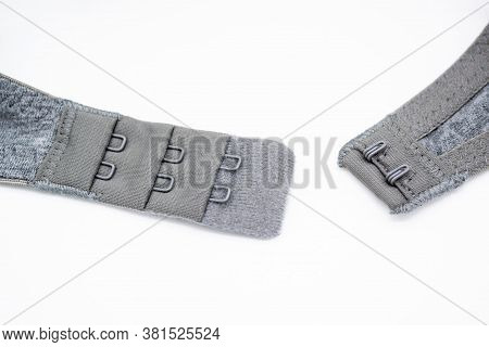 Close-up Of A Grey Cotton Bra With Hooks On A White Background