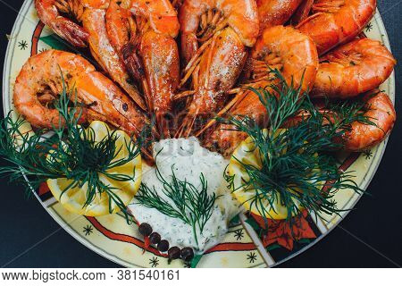 Shrimps With Lemon And Black Pepper On Dark Background