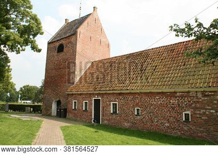 Ezinge.august-16-2020. Church Tower And A House In The Village Ezinge. The Netherlands