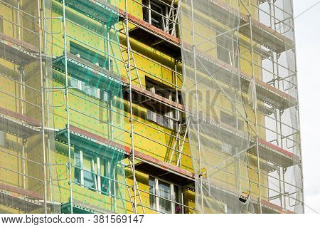 Scaffolding Arround The House To Install Thermal Insulation Of The Apartment Building Facade