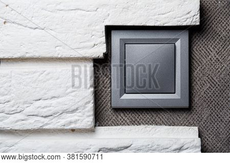 Two-key Switch Of Gray Color Near The Door, Plastic Mechanical Switch. The Light Switch Is Installed