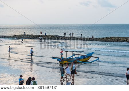Kuta, Bali / Indonesia - 11/22/2016 Balinese Jukung Sitting On The Beach Ready For Fun In The Sun
