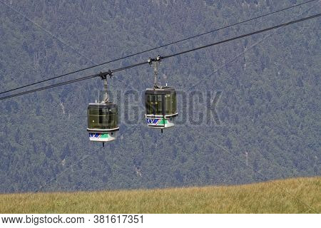 Oz-en-oisans, France, July 29, 2020 : Cabins Of One Of Numerous Cable-cars Leading To The Ski Tracks
