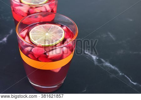 Closeup A Glass Of Red Wine Sangria With Blurry Another Glass And In The Backdrop