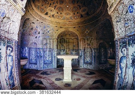 Lisbon, Portugal - February 6, 2019: Small Chapel Covered By Painted Tiles And Seashells In The Gard