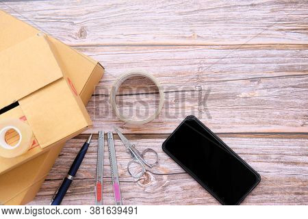 Delivery Box On Wood Table Background. Online Selling \nconcept