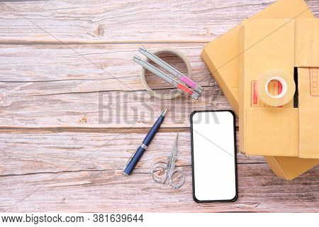 Delivery Box On Wood Table Background. Online Selling \nconcept