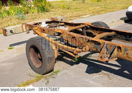 Old Rusty Car Frame, Shock Absorber, Truck Wheel.