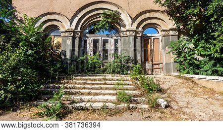 An Old Open Outer Stone Staircase. Stone, Cement Steps Of The Old Staircase With Traces Of Weatherin