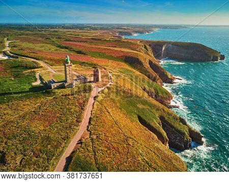 Scenic View Of Cape Frehel With Its Lighthouse, One Of The Most Popular Tourist Destinations In Brit