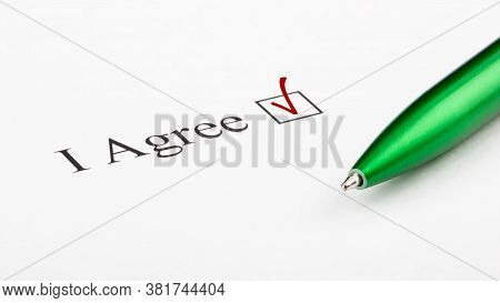 Text I Agree Checkbox On White Paper With Green Pen. Checklist Concept.