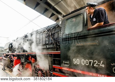 Goeppingen, Germany - September 19, 2015: A Train Driver Is Starting The Engines Of An Old Steam Loc