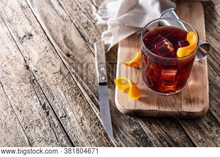 Boulevardier Cocktail And Orange Zest On Wooden Table. Copy Space