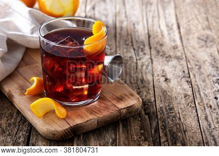 Boulevardier Cocktail And Orange Zest On Wooden Table.copy Space