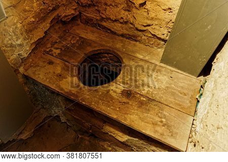 Primitive toilet in medieval castle, Serralunga d'Alba, Piedmont, Italy, toned