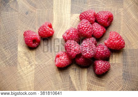 Close-up Raspberries On Wooden Background With Copy Space. Sweet Raspberries On Wooden Table. Close 