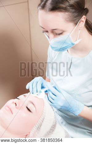 A Professional Beautician Makes An Injection To A Female Client. Hylauronic Acid For Injections In A