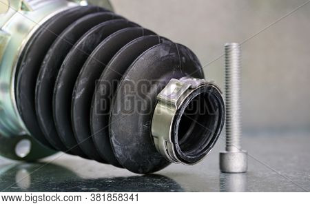 New Protective Cover For The Drive Shaft Of A Modern Car On A Steel Background. The Part Prevents Di