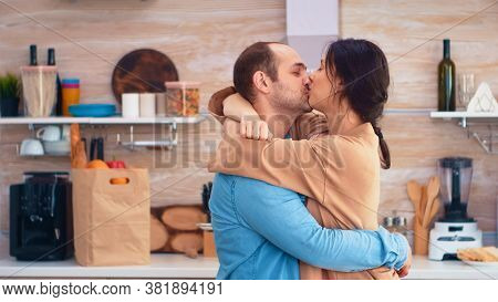 Charming Married Couple Full Of Happiness Dancing In Kitchen. Cheerful Happy Young Family Together D