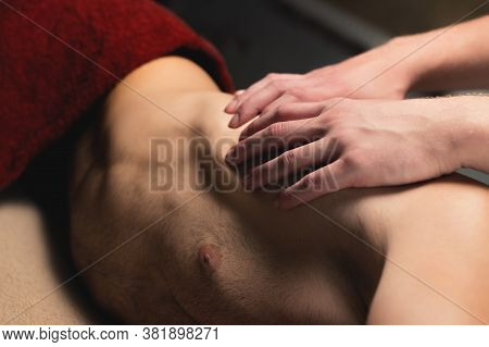 Professional Sports Massage Male Masseur Makes An Athlete A Man. Latissimus Dorsi Lats Massage