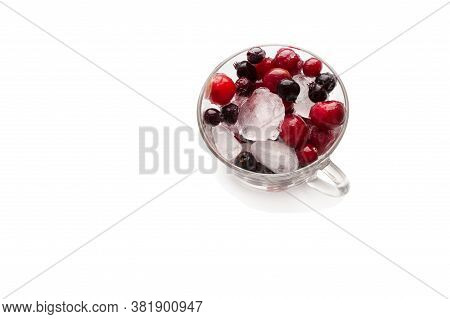 Frozen Berries With Ice In The Mug On A White Background.