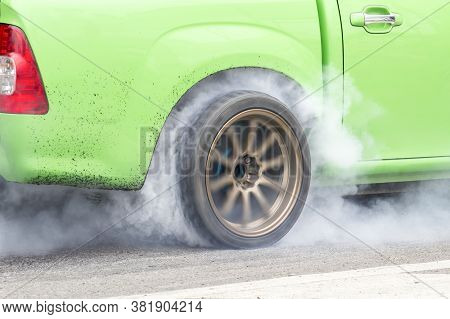 Race Car Burns Rubber Off Its Tires In Preparation For The Race