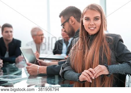 Smiling bank manager greets a warm personality with a bright wid