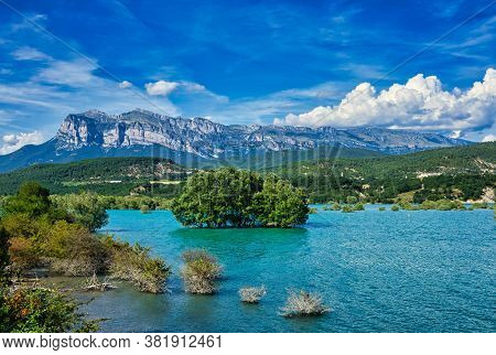 Landscape In Spain With Cinca River And Pyrenees Mountains In Background