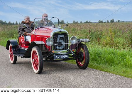Weerribben, The Netherlands- September 03, 2011: Senior Couple Riding With A Classic Ford Oldtimer T