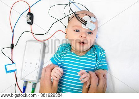 Newborn Hearing Screening And Diagnosis At The Hospital. Baby Having Hearing Screening With Special 