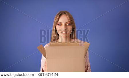 Young Caucasian Woman With Packed Cardboard Boxes And Surprised Face Isolated On The Blue Background