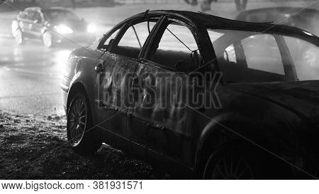 Badly Damaged Car At The Scene Of A Collision In Winter Conditions At Night. Black And White. High Q