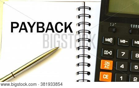 Payback Word In A Notebook Against The Background Of Calculitar. Business And Finance Concept.