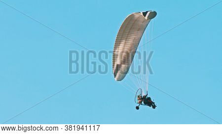 Paramotor Tandem Gliding And Flying In The Air. Copy Space. High Quality Photo