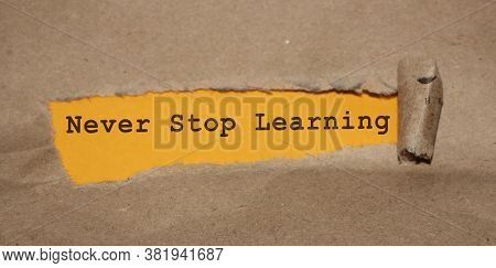 Brown Torn Paper And Yellow Background With Never Stop Learning Written