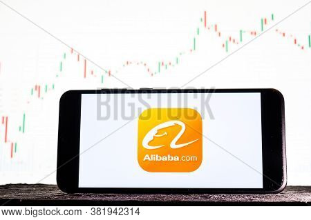Tula, Russia - August 10, 2020: Logo Alibaba On A Smartphone Against The Background Of Stock Market 