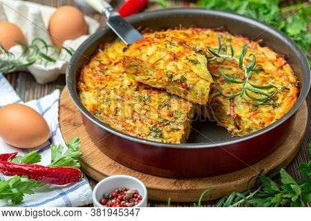 Vegetable Kugel Of Zucchini, Carrots, Potatoes, Garlic And Turmeric In A Round Baking Dish. Dish Of 